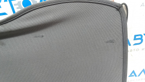 The trunk shelf of the Chevrolet Bolt 17-21 is dark gray and torn.