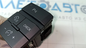 The Audi Q7 4L parking assist and instrument panel lighting button has 10-15 dents.