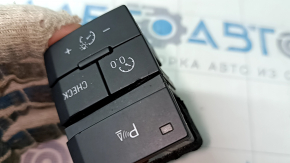 The Audi Q7 4L parking assist and instrument panel lighting button has 10-15 dents.