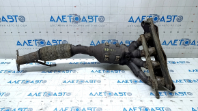 The exhaust manifold with a catalytic converter on a Ford Fusion mk5 17-20 hybrid is rusty and the mesh is torn.
