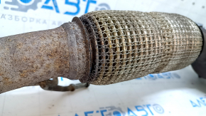 The exhaust manifold with a catalytic converter on a Ford Fusion mk5 17-20 hybrid is rusty and the mesh is torn.