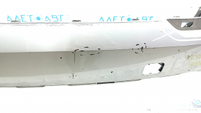 The bare lower rear bumper of a Volvo XC90 16-23, with parking sensors, beige, scratches