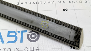 The lower front right door trim for the Lexus RX300 RX330 RX350 RX400h 04-08 is missing a guide and has scratches.
