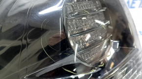 The outer taillight on the left wing of a Lexus RX350 RX400h 06-07 is dark, with spider webs and scratches.