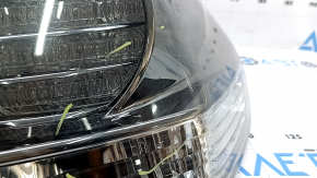 The outer right fender light of a Lexus RX350 RX400h 06-07 is dark, with spider webs and scratches.