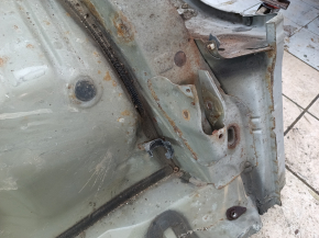 The quarter panel of the rear right Toyota Camry v40 is sawed off, silver, rusty, with bumps.