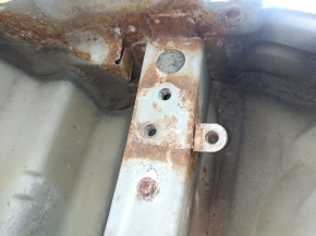 The rear panel of the Toyota Camry v40 is drilled, silver, rusty