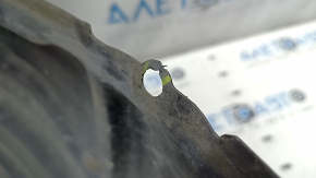The front right fender liner of a Toyota Camry v40 has a torn mount.