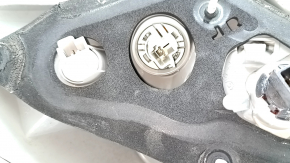 The outer right fender light of a Toyota Camry v50 12-14 USA has a cracked glass.