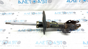 The front left shock absorber of a Toyota Camry V40 hybrid is rusty.