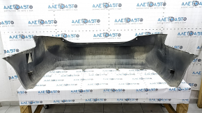 The rear bumper of a Toyota Camry V40 hybrid is bare, silver, pressed, and has cracks.