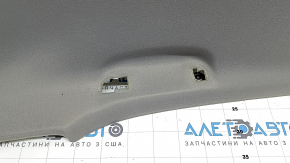 The headliner of a Toyota Camry v40 10-11 is gray, under the sunroof, creased, needs cleaning, the wiring is cut, the fabric is peeling off