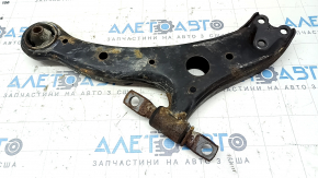 The lower front right control arm of a Toyota Camry v40 is rusty, with microcracks.