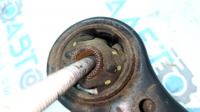 The lower front right control arm of a Toyota Camry v40 is rusty, with microcracks.