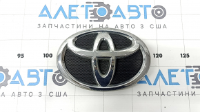 The Toyota Camry V40 grille emblem is swollen in chrome.