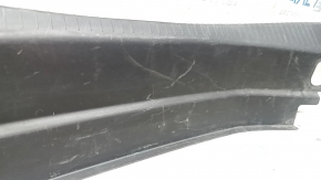 The trunk opening trim of the Cadillac CTS 14-19 is worn and scratched.