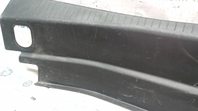 The trunk opening trim of the Cadillac CTS 14-19 is worn and scratched.