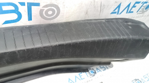 The trunk opening trim of the Cadillac CTS 14-19 is worn and scratched.