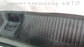 The trunk opening trim of a 1996 Dodge Dart is worn and scratched.