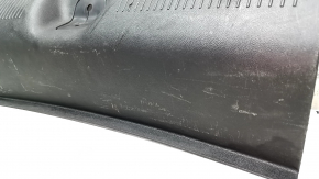 The trunk opening trim of a 1996 Dodge Dart is worn and scratched.