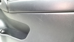 Front right door panel for a 14-16 Nissan Rogue, black with black plastic insert, glossy carbon fiber molding, leather armrest, scratches