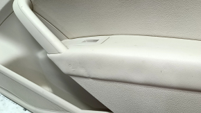 The front right door panel of the VW Passat b7 12-15 USA is beige, with a beige insert, the armrest is beige, dented, the fasteners are broken