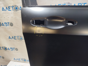The front right door of a Jeep Cherokee KL 14-23 is bare and has a small dent.