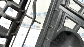 The radiator grille of a Toyota Prius V 15-17 rest is broken.
