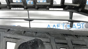 The radiator grille of a Toyota Prius V 15-17 rest is broken.