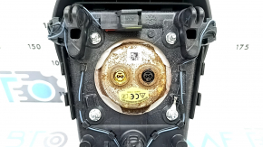The driver's side steering wheel airbag for a Ford Edge 19-24 is black and has a rusty squib.