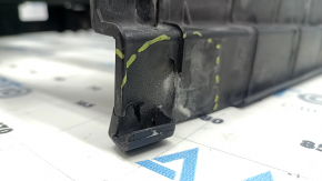The bare radiator shroud diffuser of a Toyota Prius V 12-17 is broken.