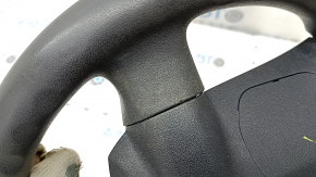 The steering wheel is bare, Toyota Prius V 12-17, black rubber, worn, needs cleaning, scrolls.