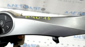 The steering wheel controls on the right side of a Toyota Prius V 2015-2017 have scratches and scuffs.