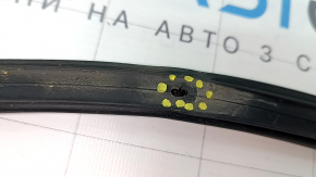 The rear left door seal of a Mitsubishi Outlander 22-25 has torn fasteners.