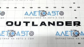 The hood emblem with the word "OUTLANDER" appears black on the Mitsubishi Outlander 22-25.