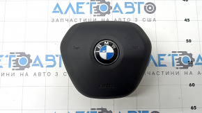 The steering wheel airbag for the driver's side of a BMW 3 G20 19-24 is black, with a rusty squib and scratches.