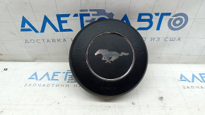 The steering wheel airbag on the driver's side of the Ford Mustang mk6 18 is rusty.