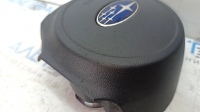 The driver's side airbag in the steering wheel of a 1920s Subaru Legacy, pre-restoration, has scratches and a rusty squib.