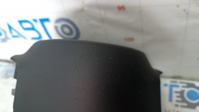 The driver's side airbag in the steering wheel of a 1920s Subaru Legacy, pre-restoration, has scratches and a rusty squib.