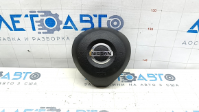 The driver's side airbag in the steering wheel of a Nissan Rogue 17-20 is black and scratched.