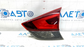 The right inner taillight on the trunk lid of a Nissan Rogue 17-20 is worn.