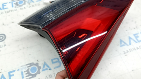 The right inner taillight on the trunk lid of a Nissan Rogue 17-20 is worn.