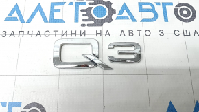 The Q3 emblem on the tailgate of the Audi Q3 83A 19-25 chrome