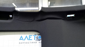 The headliner of the Audi A3 8V 15-16 4d is black, under the sunroof, dented, torn.