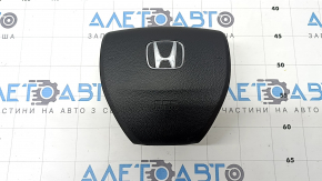 Black steering wheel airbag for the driver's side of a 1993 Honda Accord.