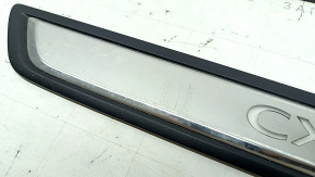 A set of black door sill plates for the Mazda CX-5 17-25 with a chrome insert and backlight, scratches