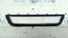 A set of black door sill plates for the Mazda CX-5 17-25 with a chrome insert and backlight, scratches