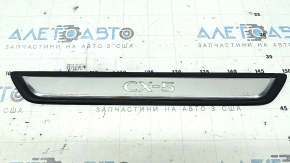 A set of black door sill plates for the Mazda CX-5 17-25 with a chrome insert and backlight, scratches