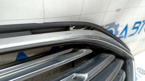 The grille assembly with frame for Ford Fusion mk5 2017-2018 is sand-painted and the mount is broken.