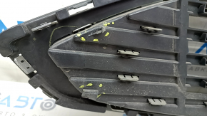 The grille assembly with frame for Ford Fusion mk5 2017-2018 is sand-painted and the mount is broken.